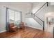 Bright living room with hardwood floors, staircase, and view into dining area at 10359 Tracewood Dr, Highlands Ranch, CO 80130