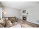 Cozy living room with a brown sectional couch and decorative fireplace at 10359 Tracewood Dr, Highlands Ranch, CO 80130