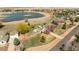Beautiful aerial view of home with lake access, in-ground pool, trampoline, fenced yard, and mature landscaping at 212 Mulligan Lake Dr, Mead, CO 80542