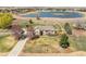 Aerial view of house, with large yard, mature landscaping, driveway, trees, and white picket fence at 212 Mulligan Lake Dr, Mead, CO 80542