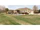 Backyard with an in-ground pool, water slide, covered patio, and spacious lawn at 212 Mulligan Lake Dr, Mead, CO 80542