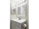 This is a bright bathroom with a white countertop, gray cabinet and a framed mirror at 212 Mulligan Lake Dr, Mead, CO 80542