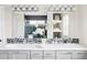 Elegant bathroom features dual sinks with a large mirror and decorative accents at 212 Mulligan Lake Dr, Mead, CO 80542
