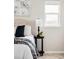 A decorative side table in the bedroom with a lamp and decor accents at 212 Mulligan Lake Dr, Mead, CO 80542