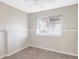 This bedroom features neutral walls, tan carpet, a chair rail, and a bright window at 212 Mulligan Lake Dr, Mead, CO 80542