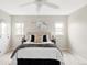 Bright bedroom with neutral color scheme, ceiling fan, and a bed with decorative pillows and throw at 212 Mulligan Lake Dr, Mead, CO 80542