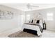 Neutral bedroom featuring a well-lit space, art, a large bed, and bedside tables with lamps at 212 Mulligan Lake Dr, Mead, CO 80542
