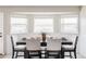 Bright dining area features a dark wood table, seating for four, and a window with views of the outdoors at 212 Mulligan Lake Dr, Mead, CO 80542