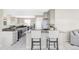 Modern kitchen with stainless steel appliances, granite countertops, tile floors, eat-in island and dining area at 212 Mulligan Lake Dr, Mead, CO 80542