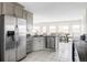 Bright kitchen with stainless steel appliances, granite countertops, tile floors, and a dining area at 212 Mulligan Lake Dr, Mead, CO 80542
