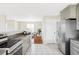 Bright kitchen with stainless steel appliances, granite countertops, tile floors and eat-in dining area at 212 Mulligan Lake Dr, Mead, CO 80542