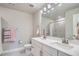 Bathroom with double vanity sinks, white cabinets, and modern fixtures at 9786 Rosalee Peak St, Littleton, CO 80125