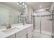 Modern bathroom with double sinks, sleek glass shower, and elegant tile, creating a spa-like experience at 9786 Rosalee Peak St, Littleton, CO 80125