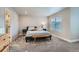 Comfortable bedroom featuring soft carpet, a serene ambiance, and natural light from the window at 9786 Rosalee Peak St, Littleton, CO 80125