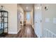 Welcoming entryway with hardwood floors, white trim, and natural light streaming in from the front door at 9786 Rosalee Peak St, Littleton, CO 80125