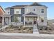 Attractive two-story home featuring a stone-accented facade, covered porch, and manicured front yard at 9786 Rosalee Peak St, Littleton, CO 80125