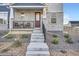 Inviting front porch with stone accents, wrought iron railing, and a seating area for relaxation at 9786 Rosalee Peak St, Littleton, CO 80125