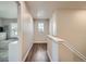 Hallway boasts hardwood floors and natural light from the window on the far wall at 9786 Rosalee Peak St, Littleton, CO 80125
