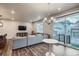 Spacious living room with large window, providing ample natural light, and a stylish light grey sofa at 9786 Rosalee Peak St, Littleton, CO 80125