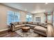 Bright and spacious living room with a comfortable sectional sofa, stylish rug, and modern lighting fixtures at 9786 Rosalee Peak St, Littleton, CO 80125