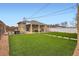 Expansive backyard featuring artificial turf, a covered patio, and space for outdoor entertaining at 3020 Niagara St, Denver, CO 80207