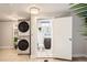 Modern bathroom with stacked washer/dryer, sleek fixtures, and a tiled floor at 3020 Niagara St, Denver, CO 80207