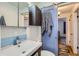 Modern bathroom features blue and white tiles, updated vanity, and sleek fixtures at 3020 Niagara St, Denver, CO 80207
