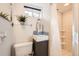 Compact, modern bathroom with neutral tiling, sleek fixtures, and shower at 3020 Niagara St, Denver, CO 80207