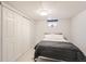 Cozy bedroom featuring a comfortable bed and a closet with sliding doors at 3020 Niagara St, Denver, CO 80207