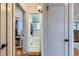 Hallway view showcasing access to a home office, bathroom, and kitchen at 3020 Niagara St, Denver, CO 80207
