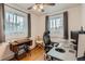 Bright home office featuring a work station, multiple windows, and hardwood floors at 3020 Niagara St, Denver, CO 80207