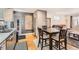 Kitchen with stainless steel appliances, dining area, wood floors, and modern finishes at 3020 Niagara St, Denver, CO 80207