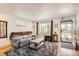 Inviting living room with a couch, natural light, decorative rug, and stylish accents at 3020 Niagara St, Denver, CO 80207