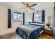 Comfortable main bedroom featuring a ceiling fan, plush bedding, and window treatments at 3020 Niagara St, Denver, CO 80207
