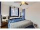 Serene bedroom with a ceiling fan, comfortable bedding, and natural light from the window at 3020 Niagara St, Denver, CO 80207