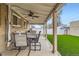 Covered patio with dining area overlooking a well maintained lawn at 3020 Niagara St, Denver, CO 80207