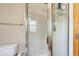 Bathroom with a shower featuring glass door and tile surround near the toilet with towel bar at 3354 Wabash St, Denver, CO 80238