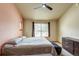 Bedroom featuring neutral tones, a ceiling fan, carpet flooring, two windows, and a dresser at 3354 Wabash St, Denver, CO 80238
