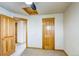 Bedroom featuring neutral walls, carpet, wooden door and doorframe at 3354 Wabash St, Denver, CO 80238