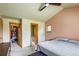 A clean bedroom featuring a ceiling fan, carpet flooring, and walk in closet with an adjoined bathroom at 3354 Wabash St, Denver, CO 80238