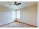 Bright bedroom features neutral walls, carpet, a ceiling fan and two windows letting in natural light at 3354 Wabash St, Denver, CO 80238