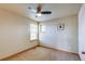 Bedroom with neutral walls, carpet, windows, ceiling fan with light, and wooden door at 3354 Wabash St, Denver, CO 80238