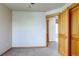 Bedroom features carpet, neutral paint, wood trim and an open closet at 3354 Wabash St, Denver, CO 80238