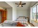 Bedroom with vaulted ceilings, a ceiling fan, and lots of natural light from the large window at 3354 Wabash St, Denver, CO 80238
