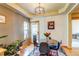 Cozy dining room with a round table and seating for four, next to the back door and a plant filled living space at 3354 Wabash St, Denver, CO 80238