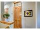 Bright entryway featuring a wooden door with decorative glass, a plant, and wall art at 3354 Wabash St, Denver, CO 80238