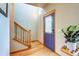 Entryway featuring a staircase, hardwood floors, and a blue front door with a window at 3354 Wabash St, Denver, CO 80238