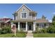Charming gray two-story home featuring a welcoming front porch and manicured lawn at 3354 Wabash St, Denver, CO 80238