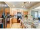 Bright kitchen with modern appliances, light wood cabinets, granite countertops, and an island that provides extra workspace at 3354 Wabash St, Denver, CO 80238