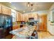Well-equipped kitchen boasts a center island, stainless steel appliances and wooden cabinetry at 3354 Wabash St, Denver, CO 80238